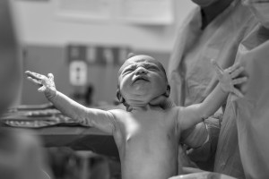 newborn babe arms outstretched